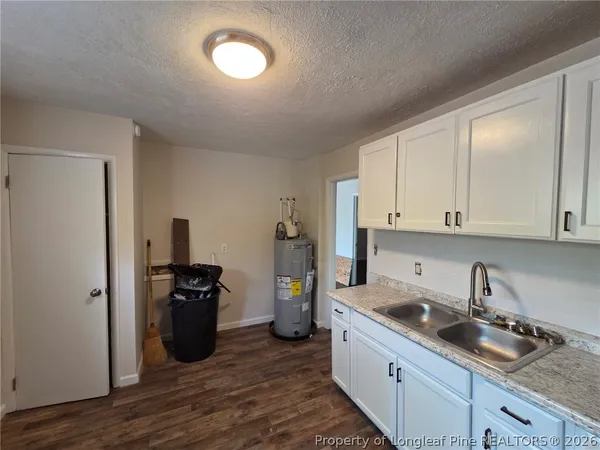 a kitchen with sink cabinets and stainless steel appliances