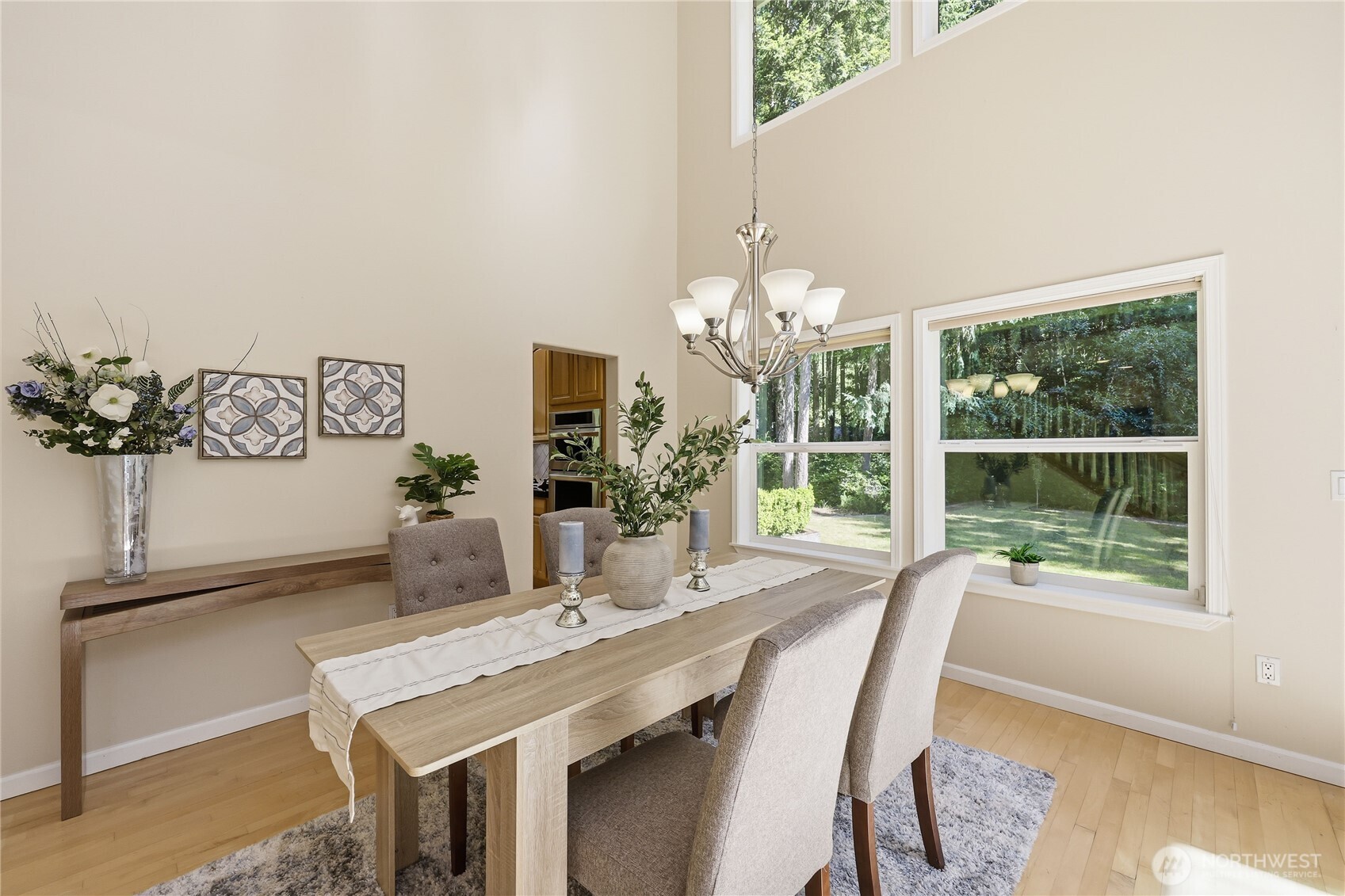 4354 Northwest Westgate Road Silverdale, WA 98383 - Photo 6 of 40 a view of a dining room with furniture a chandelier and wooden floor