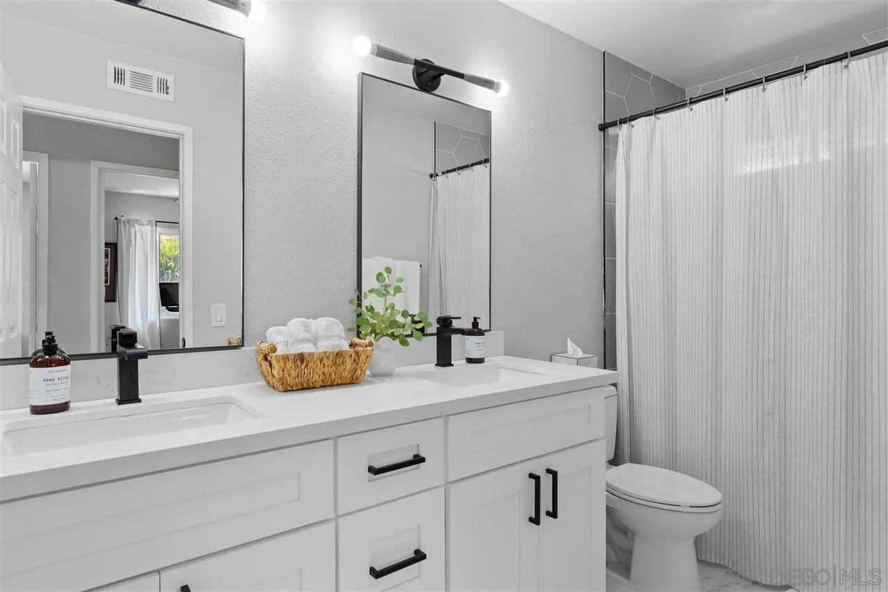 1517 Vanessa Circle Encinitas, CA 92024 - Photo 25 of 26 a bathroom with a double vanity sink mirror and toilet
