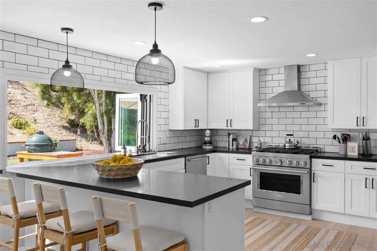 1517 Vanessa Circle Encinitas, CA 92024 - Photo 8 of 26 a kitchen with stainless steel appliances granite countertop a sink a stove and a wooden floors