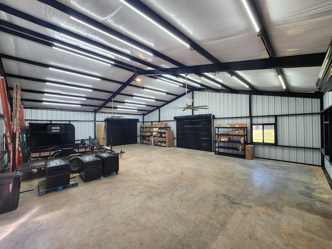 102 County Road 180 Leander, TX 78641 - Photo 22 of 25 A spacious, well-lit workshop offers ample room for projects and storage.