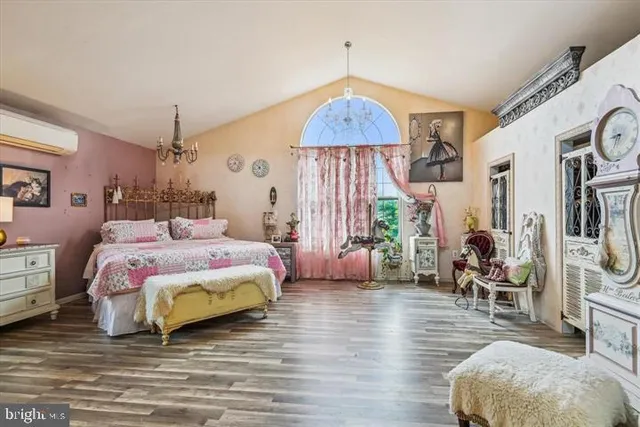 a bedroom with a bed and a chandelier