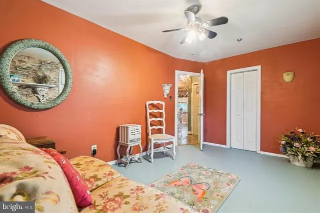 a bed sitting in a bedroom next to a window and a chandelier