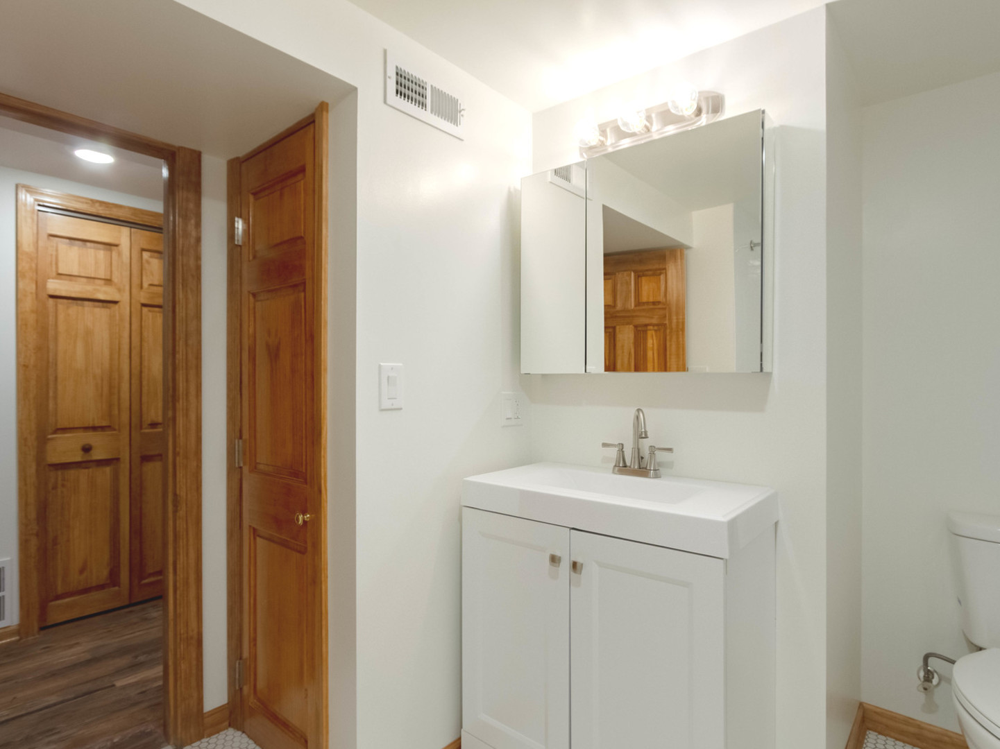 1439 North Springfield Avenue Chicago, IL 60651 - Photo 25 of 35 a bathroom with a sink and a mirror