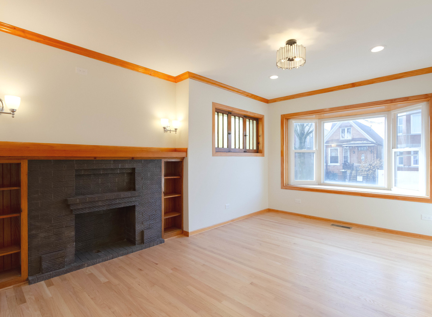 1439 North Springfield Avenue Chicago, IL 60651 - Photo 3 of 35 a view of an empty room with a window and fireplace