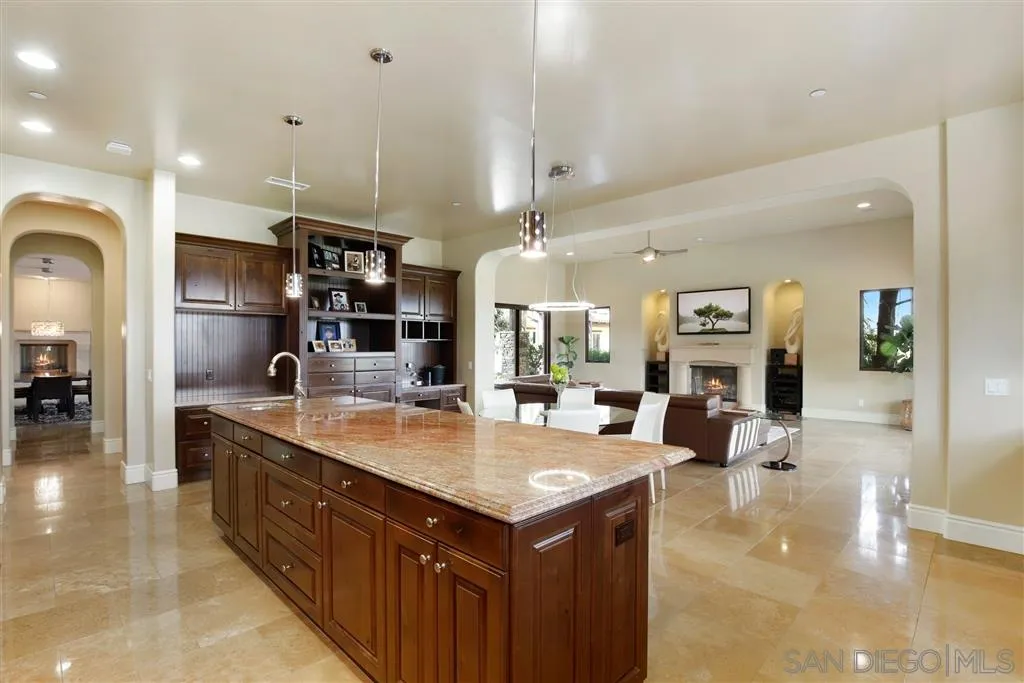 4142 Bridlewood Road Fallbrook, CA 92028 - Photo 11 of 25 a large kitchen with kitchen island a large counter top appliances and cabinets
