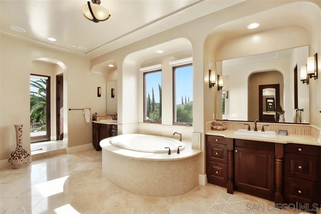 4142 Bridlewood Road Fallbrook, CA 92028 - Photo 14 of 25 a bathroom with a tub sink shower and mirror