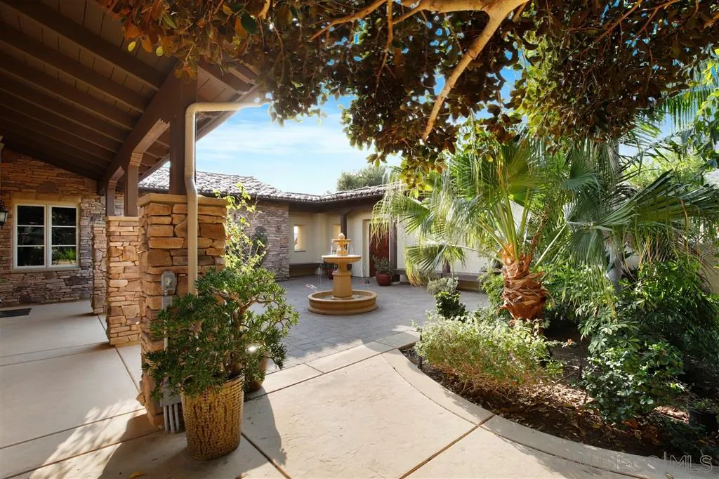 4142 Bridlewood Road Fallbrook, CA 92028 - Photo 3 of 25 a view of a patio with table and chairs and potted plants