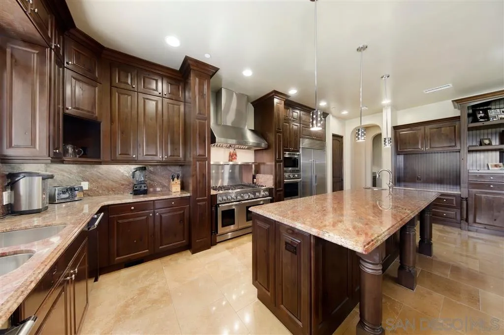 4142 Bridlewood Road Fallbrook, CA 92028 - Photo 10 of 25 a kitchen with stainless steel appliances granite countertop a sink a stove and a refrigerator