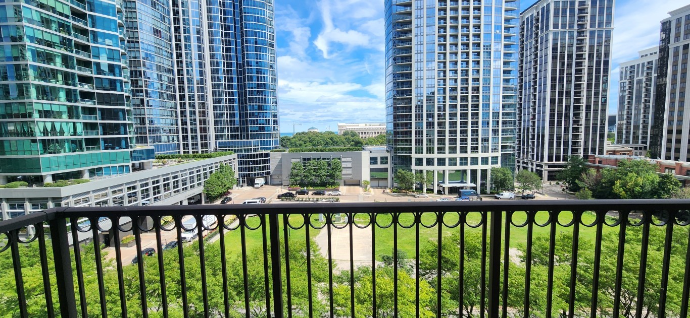 1250 South Indiana Avenue, Unit 802 Chicago, IL 60605 - Photo 15 of 20 a view of a balcony with a floor to ceiling window and wooden fence