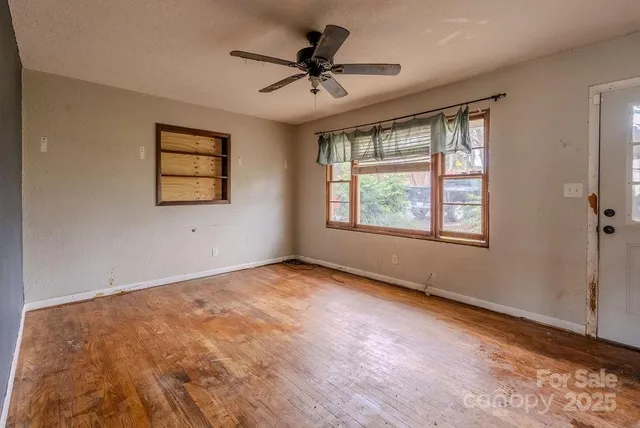 a view of a livingroom with a ceiling fan and window