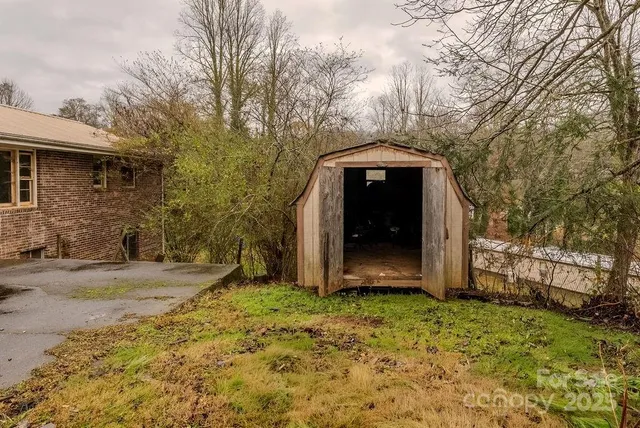 a view of a house with a large tree
