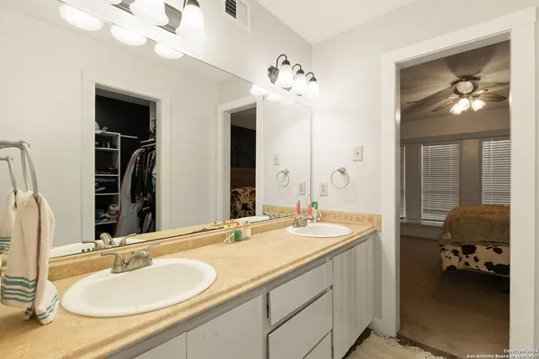 a en suite bathroom with double vanity and a mirror