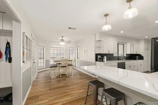 a large kitchen with a table and chairs