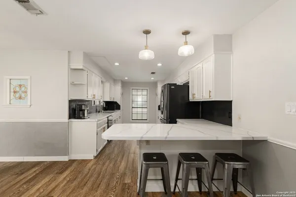 a kitchen with a sink a stove and cabinets