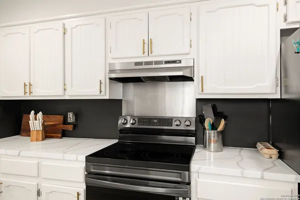 a kitchen with cabinets and stainless steel appliances