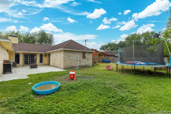 a backyard of a house with portable swimming pool and outdoor seating