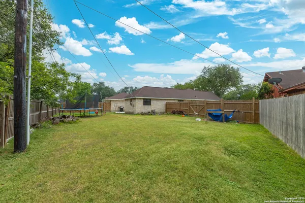a view of a house with a yard and sitting area