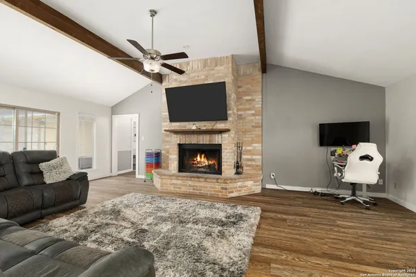 a living room with furniture and a fireplace