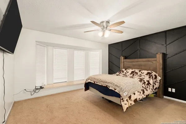 a bedroom with a bed and a window