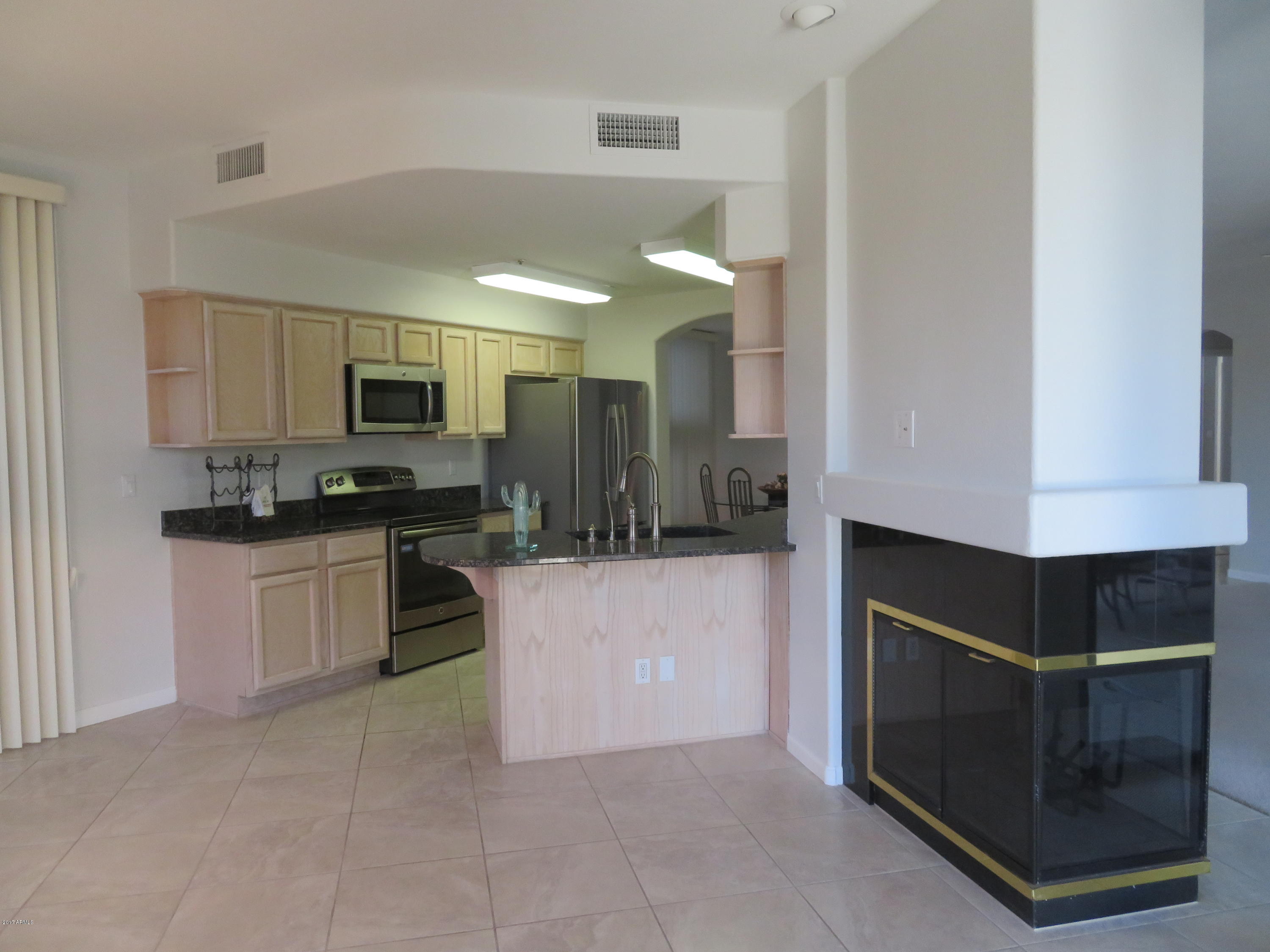 7700 East Gainey Ranch Road, Unit 123 Scottsdale, AZ 85258 - Photo 12 of 40 FIREPLACE IN FAMILY ROOM
