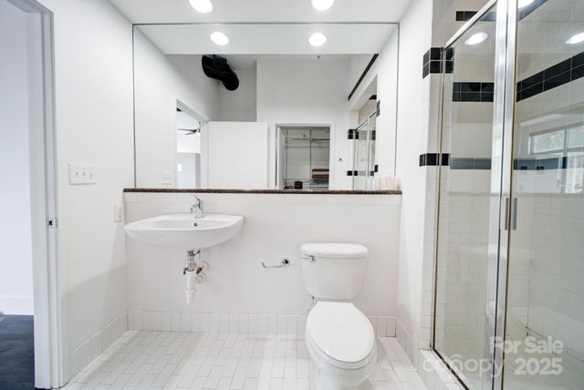a bathroom with a toilet sink and shower