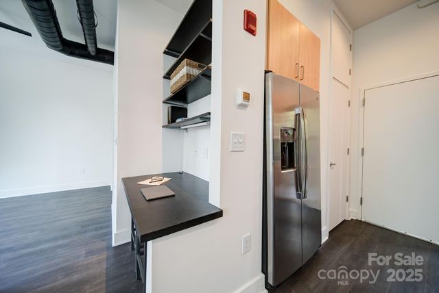 a view of hallway with cabinets and wooden floor