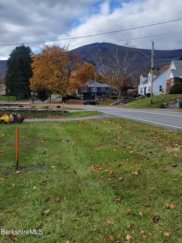 a view of yard with swimming pool and green space