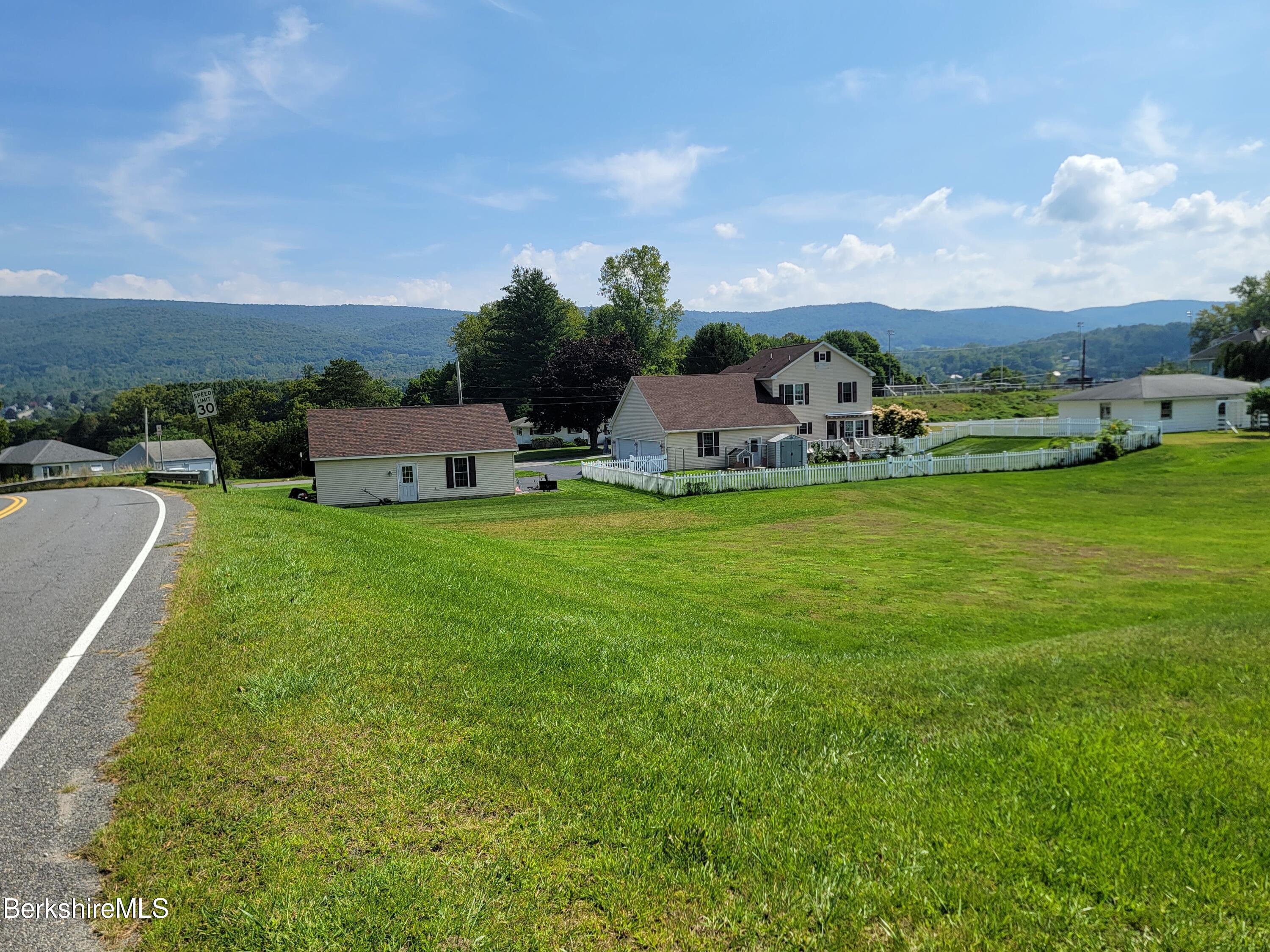 0 Friend Street Adams, MA 01220 - Photo 8 of 8 a view of a swimming pool with lawn chairs and large trees