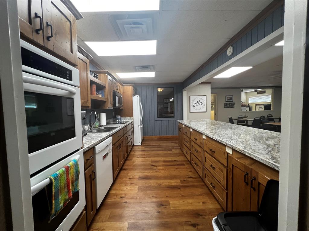 Lot 7 King Sebastian Road Scroggins, TX 75480 - Photo 38 of 40 a large open kitchen with stainless steel appliances kitchen island granite countertop a large counter top