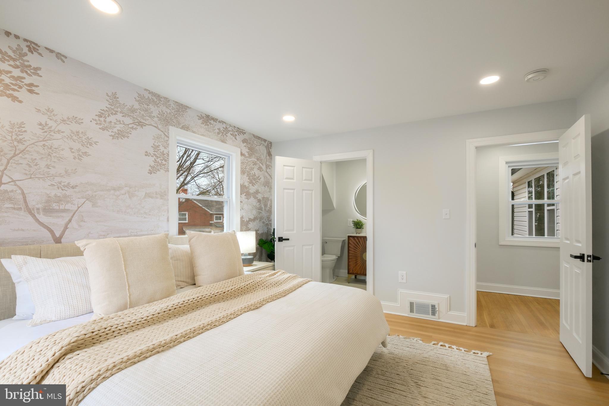 617 Greenbrier Drive Silver Spring, MD 20910 - Photo 17 of 60 a spacious bedroom with a bed and a couch