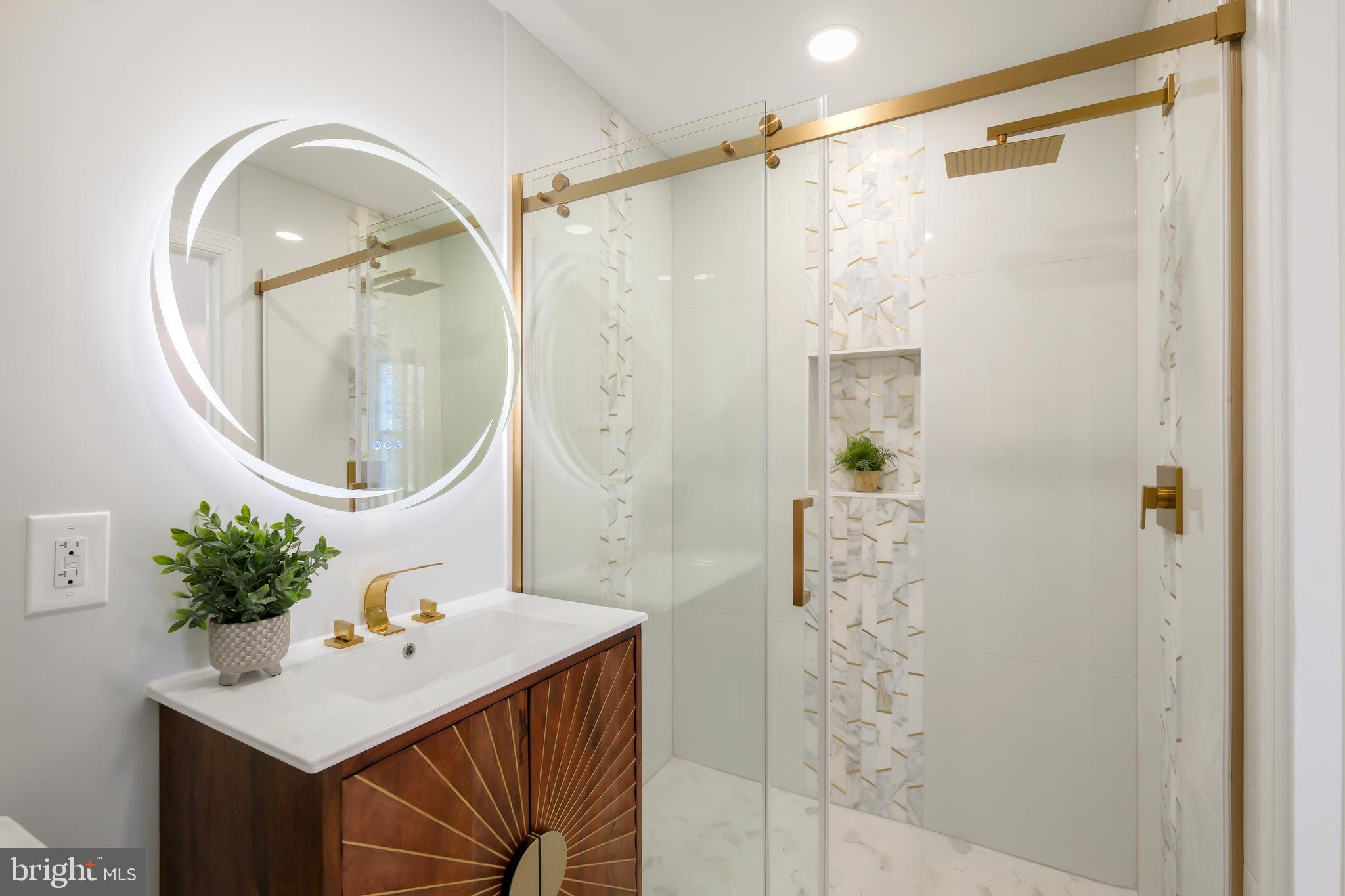617 Greenbrier Drive Silver Spring, MD 20910 - Photo 23 of 60 a bathroom with a sink a mirror a vanity and a shower