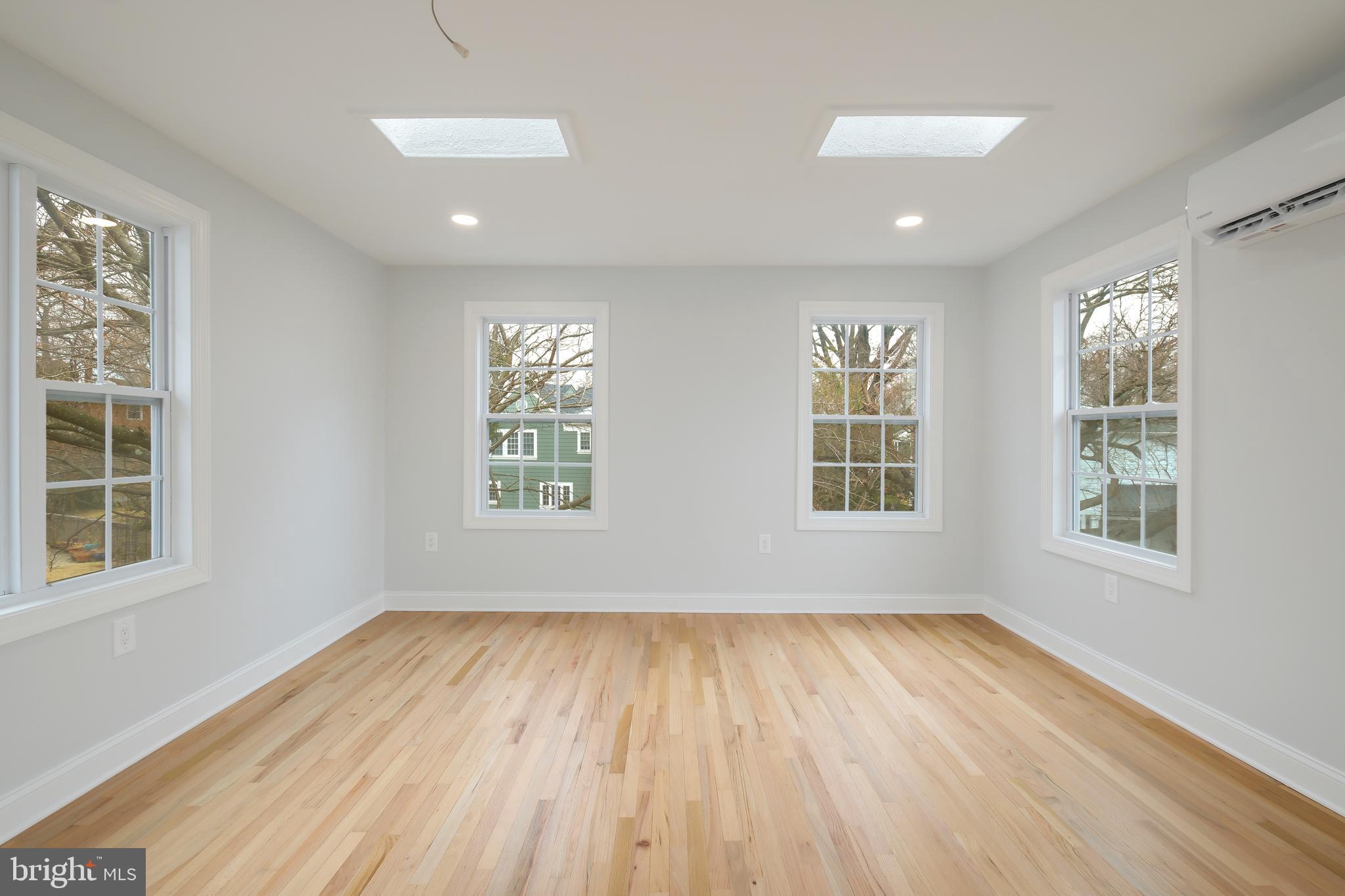 617 Greenbrier Drive Silver Spring, MD 20910 - Photo 24 of 60 an empty room with wooden floor and windows