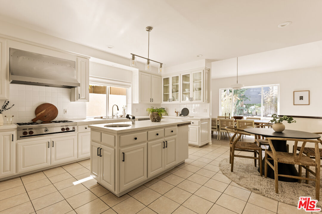 7825 Cowan Avenue Los Angeles, CA 90045 - Photo 11 of 33 a kitchen with white cabinets and chairs