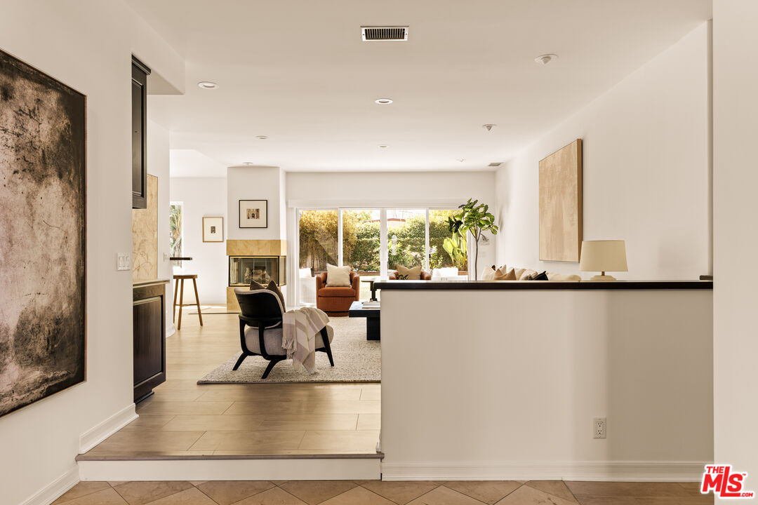 7825 Cowan Avenue Los Angeles, CA 90045 - Photo 7 of 33 a living room with fireplace furniture flat screen tv and a large window
