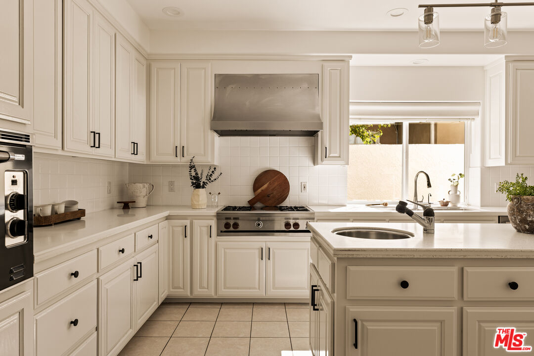7825 Cowan Avenue Los Angeles, CA 90045 - Photo 9 of 33 a kitchen with white cabinets and white appliances