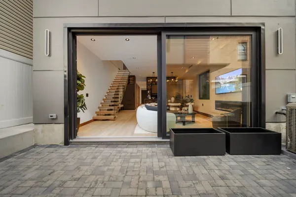 a living room with furniture and a kitchen view