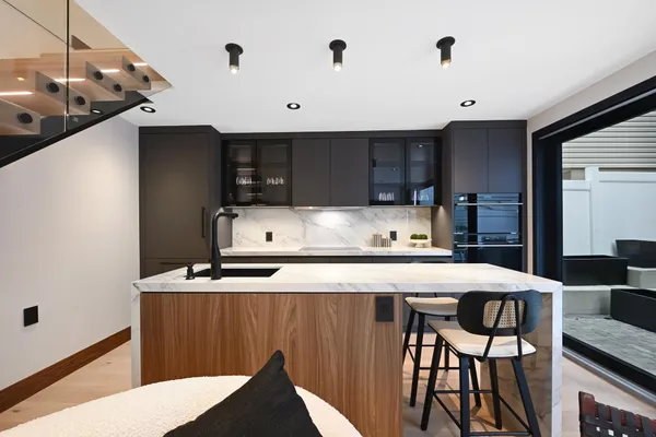 a kitchen with stainless steel appliances granite countertop a sink stove and cabinets