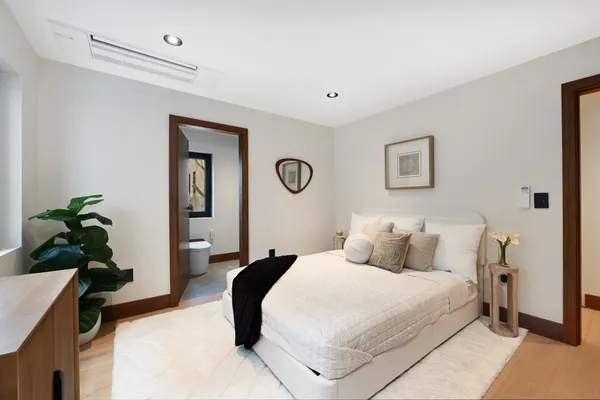 a bedroom with a bed and a painting on the wall