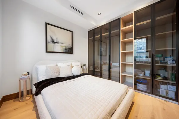 a bedroom with bed and cabinets
