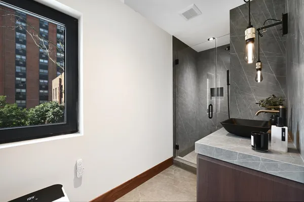 a bathroom with a sink a toilet and shower