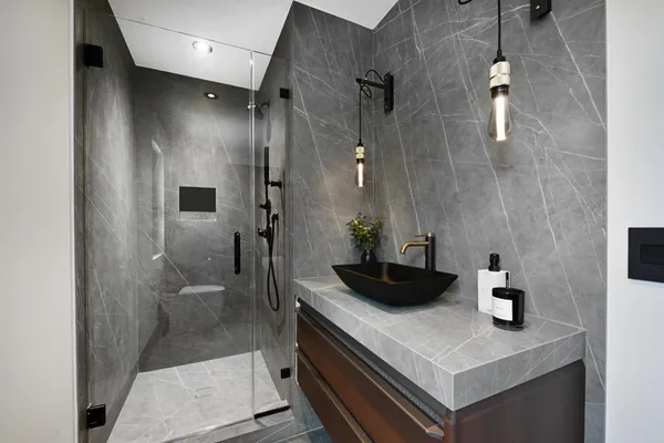 a bathroom with a sink a toilet and shower