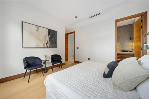 a bedroom with a bed and a chair