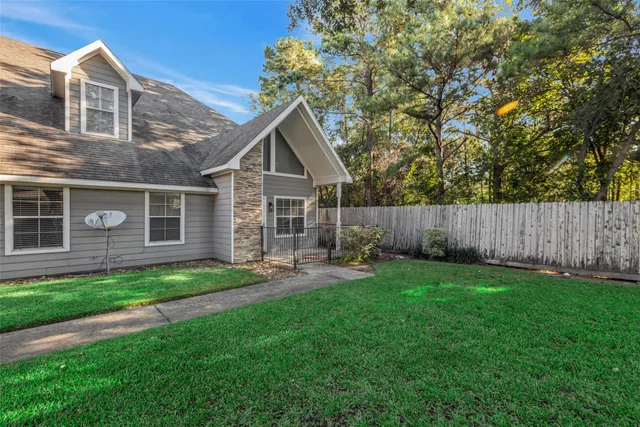 a view of a house with a yard and sitting area