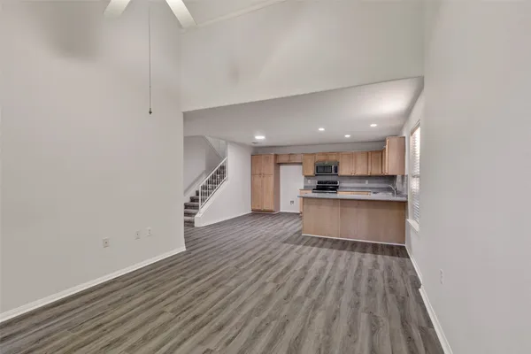 a view of kitchen with sink and refrigerator