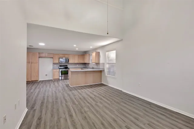 a view of kitchen with granite countertop cabinets and wooden floor