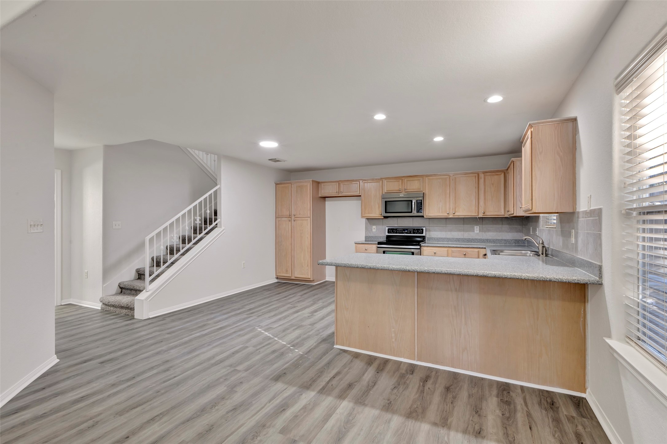 770 Hunt Road, Unit 212 Baytown, TX 77521 - Photo 16 of 40 a view of kitchen with stainless steel appliances granite countertop a stove a sink and a refrigerator