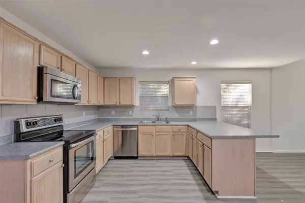 a kitchen with granite countertop a sink and cabinets