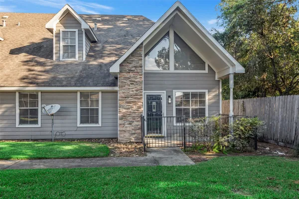 a front view of a house with a yard and porch