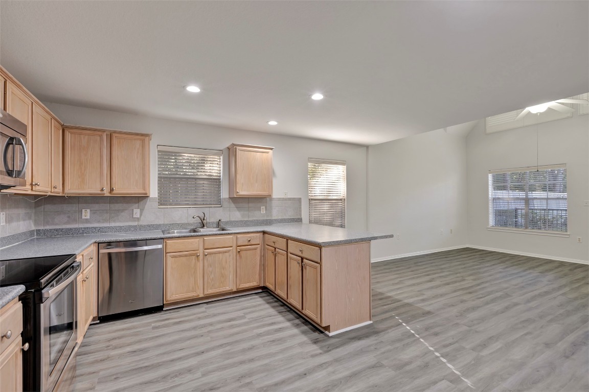 770 Hunt Road, Unit 212 Baytown, TX 77521 - Photo 21 of 40 a kitchen with granite countertop a sink and cabinets